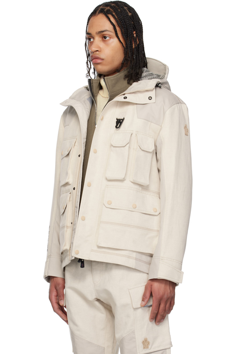 Lightweight cotton-blend canvas and broadcloth jacket.

· Windproof and waterproof 
· Paneled construction 
· Bungee-style drawstring at hood
· Concealed two-way zip closure
· Press-stud placket
· Lanyard clasp and grommets at chest
· Bellows and zip pockets  
· Suede logo patch at sleeve
· Adjustable velcro tab at cuffs
· Rubberized text bonded at cuff
· Partial mesh lining 

Part of the Day-Namic collection.

Supplier color: Soft beige