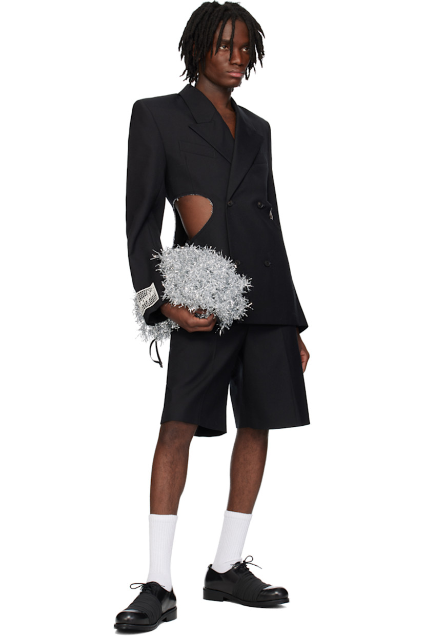 Wool twill blazer.

· Peaked lapel
· Double-breasted button closure
· Welt pockets at chest
· Darts at front
· Cutouts with raw edges at waist and elbows
· Padded shoulders
· Surgeon's cuffs
· Embroidered logo patch at cuff
· Central vent at back hem
· Full logo-woven satin lining

Supplier color: Tailoring black wool