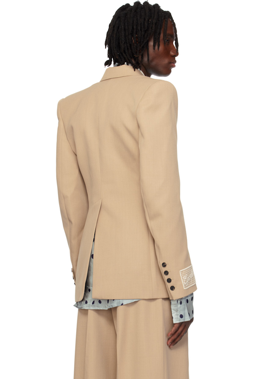 Wool twill blazer.

· Peaked lapel
· Double-breasted button closure
· Welt and flap pockets
· Padded shoulders
· Surgeon's cuffs
· Embroidered logo patch at cuff
· Central vent at back hem
· Full logo-woven satin lining

Supplier color: Tailoring nude wool
