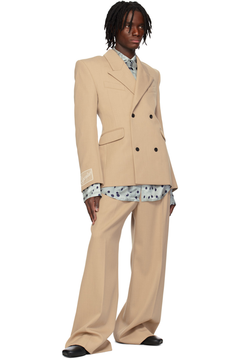 Wool twill blazer.

· Peaked lapel
· Double-breasted button closure
· Welt and flap pockets
· Padded shoulders
· Surgeon's cuffs
· Embroidered logo patch at cuff
· Central vent at back hem
· Full logo-woven satin lining

Supplier color: Tailoring nude wool