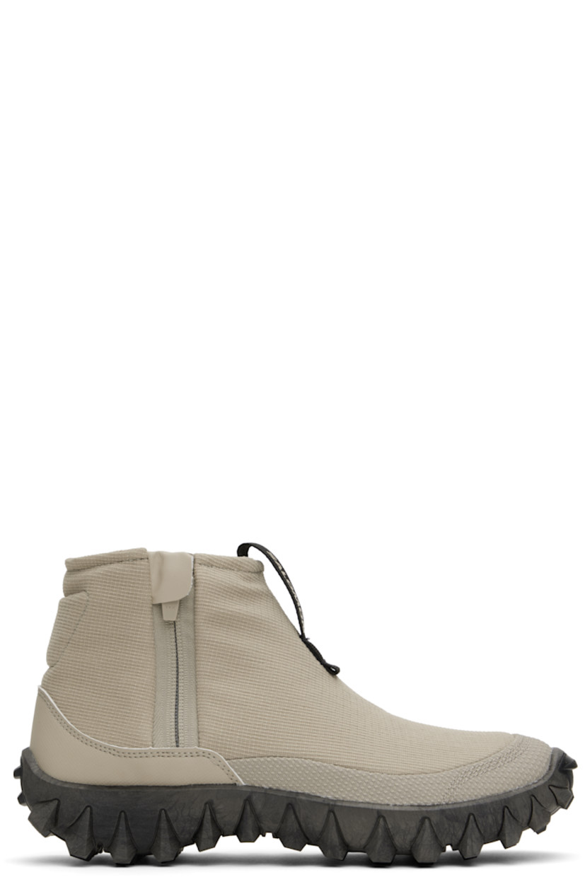 Mid-top PFC-free ripstop sneakers in gray.

· Water-repellent
· Logo-bonded pull-loop at vamp
· Padded collar
· Zip closure at outer side
· Logo bonded at heel counter
· Wool fleece insole and lining
· infiniFOAM® foam rubber midsole
· Treaded All Terrain Contagrip® sole

Supplier color: Feather gray/Black