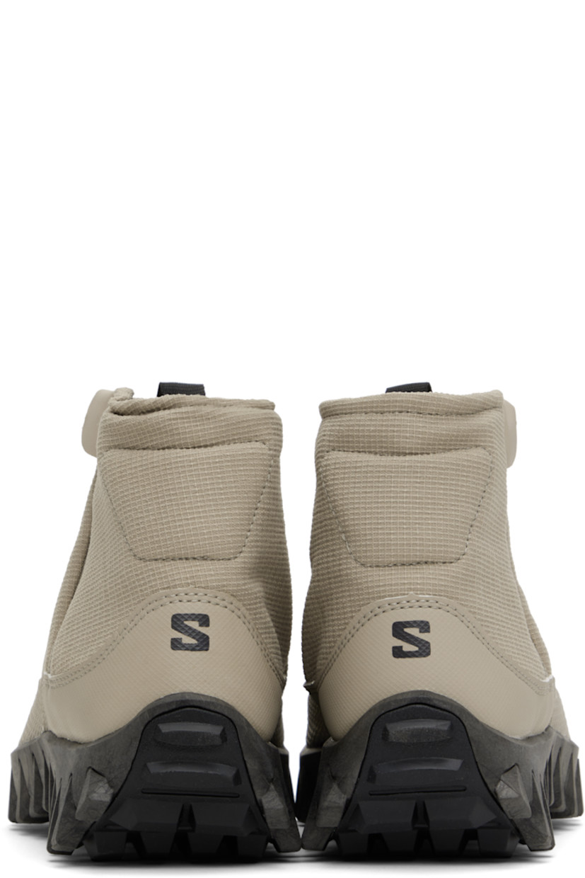 Mid-top PFC-free ripstop sneakers in gray.

· Water-repellent
· Logo-bonded pull-loop at vamp
· Padded collar
· Zip closure at outer side
· Logo bonded at heel counter
· Wool fleece insole and lining
· infiniFOAM® foam rubber midsole
· Treaded All Terrain Contagrip® sole

Supplier color: Feather gray/Black