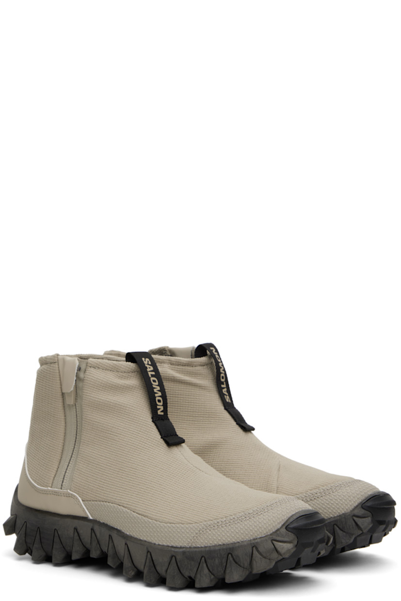 Mid-top PFC-free ripstop sneakers in gray.

· Water-repellent
· Logo-bonded pull-loop at vamp
· Padded collar
· Zip closure at outer side
· Logo bonded at heel counter
· Wool fleece insole and lining
· infiniFOAM® foam rubber midsole
· Treaded All Terrain Contagrip® sole

Supplier color: Feather gray/Black