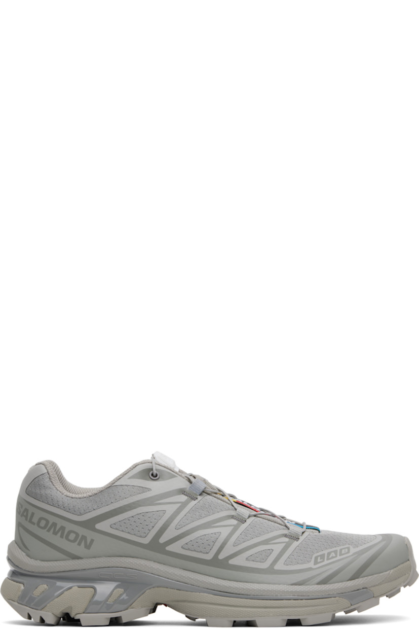Low-top lightweight mesh sneakers in gray.

· Bonded trim throughout
· Logo embossed rubber cap toe
· Quicklace™ closure
· Logo patch at vamp
· Logo patch at padded tongue
· Padded collar
· Bonded SensiFit™ panel at sides
· Logo printed at outer side
· EndoFit™ mesh lining
· Molded OrthoLite® insole
· Agile Chassis™ System at rubber EnergyCell midsole
· Treaded Mud Contagrip® rubber sole

Supplier color: Ghost gray/Gray flannel