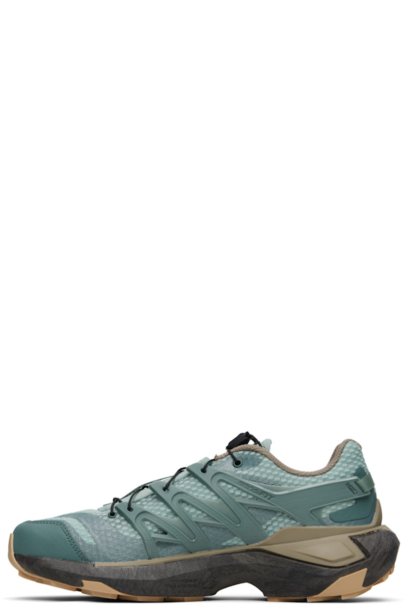 Low-top mesh sneakers in green.

· Bonded trim throughout
· Quicklace™ closure
· Logo patch at padded tongue
· Padded collar
· Logo embossed at outer side
· Rubber sensiFIT™ panel at sides
· Pull-loop at heel counter
· Molded OrthoLite® footbed
· EndoFit™ mesh lining
· infiniFOAM rubber midsole
· Treaded All Terrain Contagrip® rubber sole
· Advanced Chassis™ System at sole

Supplier color: North Atlantic/Black/Stone gray
