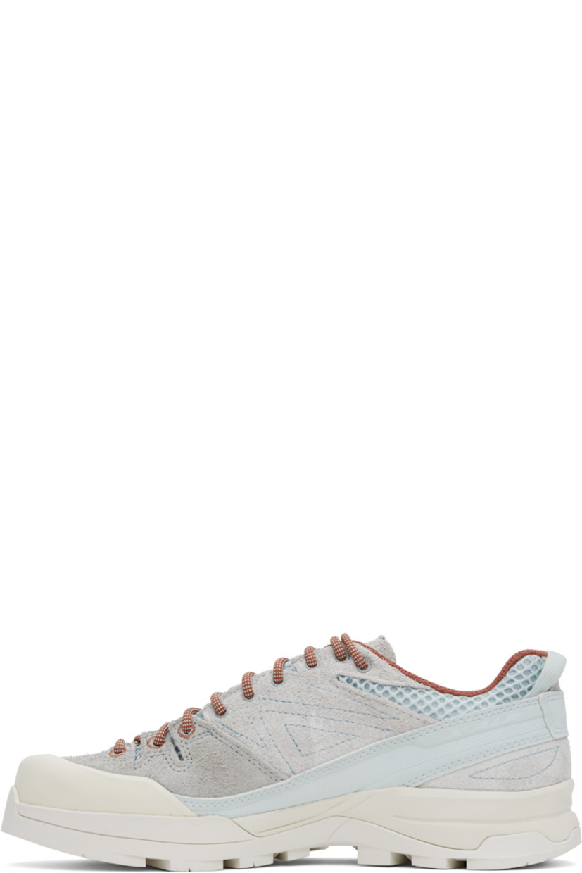 Low-top mesh and suede sneakers in gray and blue.

· Rubber cap toe
· Lace-up closure
· Logo printed at padded tongue
· Padded collar
· Logo embossed at outer side
· Pull-loop with reflective logo at heel
· Cushioned Ortholite® insole
· Mesh lining
· 3D Edging Chassis™ rubber midsole
· Treaded Contagrip® rubber sole

Supplier color: Ice flow/Quarry/Russet