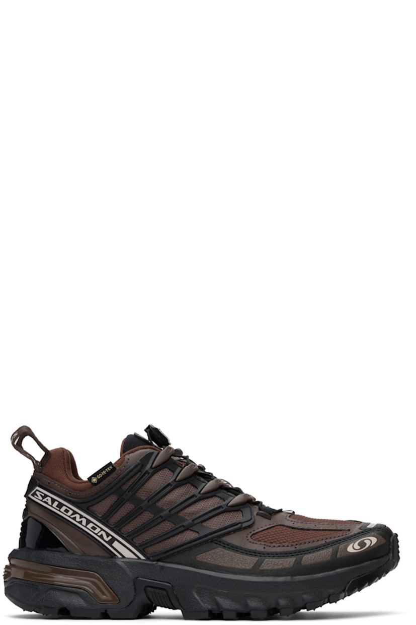 Low-top faux-leather and mesh sneakers in brown. 

· Certified OEKO-Tex® Standard and Bluesign®
· GORE-TEX™ ePE waterproof membrane, PFC-free
· Rubberized trim and bonded logos throughout
· Quicklace® closure
· Logo patch at padded tongue
· Padded collar
· SensiFit™ and sheer mesh panel at sides
· Pull-loops at heel tab
· Logo embossed at heel counter
· Molded OrthoLite® insole
· Jersey lining
· Agile Chassis™ System at rubber EnergyCell midsole
· Treaded All Terrain Contagrip® rubber sole

Supplier color: Roasted clay/Black/Rum raisin