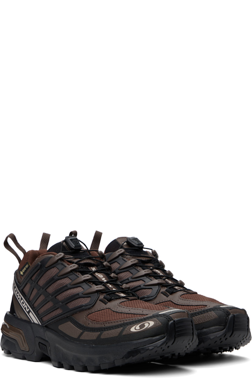 Low-top faux-leather and mesh sneakers in brown. 

· Certified OEKO-Tex® Standard and Bluesign®
· GORE-TEX™ ePE waterproof membrane, PFC-free
· Rubberized trim and bonded logos throughout
· Quicklace® closure
· Logo patch at padded tongue
· Padded collar
· SensiFit™ and sheer mesh panel at sides
· Pull-loops at heel tab
· Logo embossed at heel counter
· Molded OrthoLite® insole
· Jersey lining
· Agile Chassis™ System at rubber EnergyCell midsole
· Treaded All Terrain Contagrip® rubber sole

Supplier color: Roasted clay/Black/Rum raisin