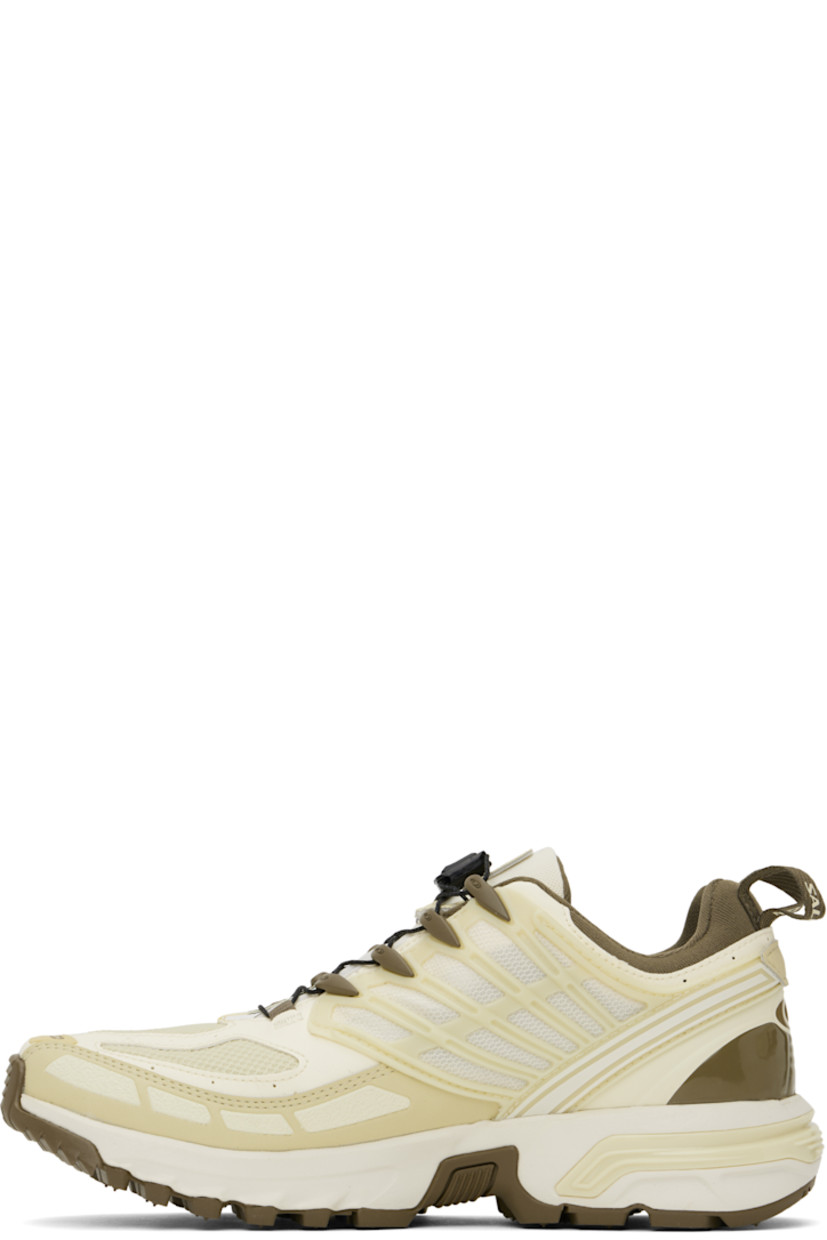 Low-top faux-leather and mesh sneakers in yellow and brown.

· Certified OEKO-Tex® Standard and Bluesign® 
· GORE-TEX™ waterproof membrane, PFC-free
· Rubberized trim and logos bonded throughout
· Quicklace® closure
· Velcro tab and logo patch at padded tongue
· Padded collar
· Logo flag at outer side
· Mesh panel at sides
· Pull-loops at heel tab
· OrthoLite® insole
· Jersey lining
· Agile Chassis™ System at rubber midsole
· Treaded Contagrip® rubber sole

Supplier color: Vanilla ice/Green haze/Stone gray