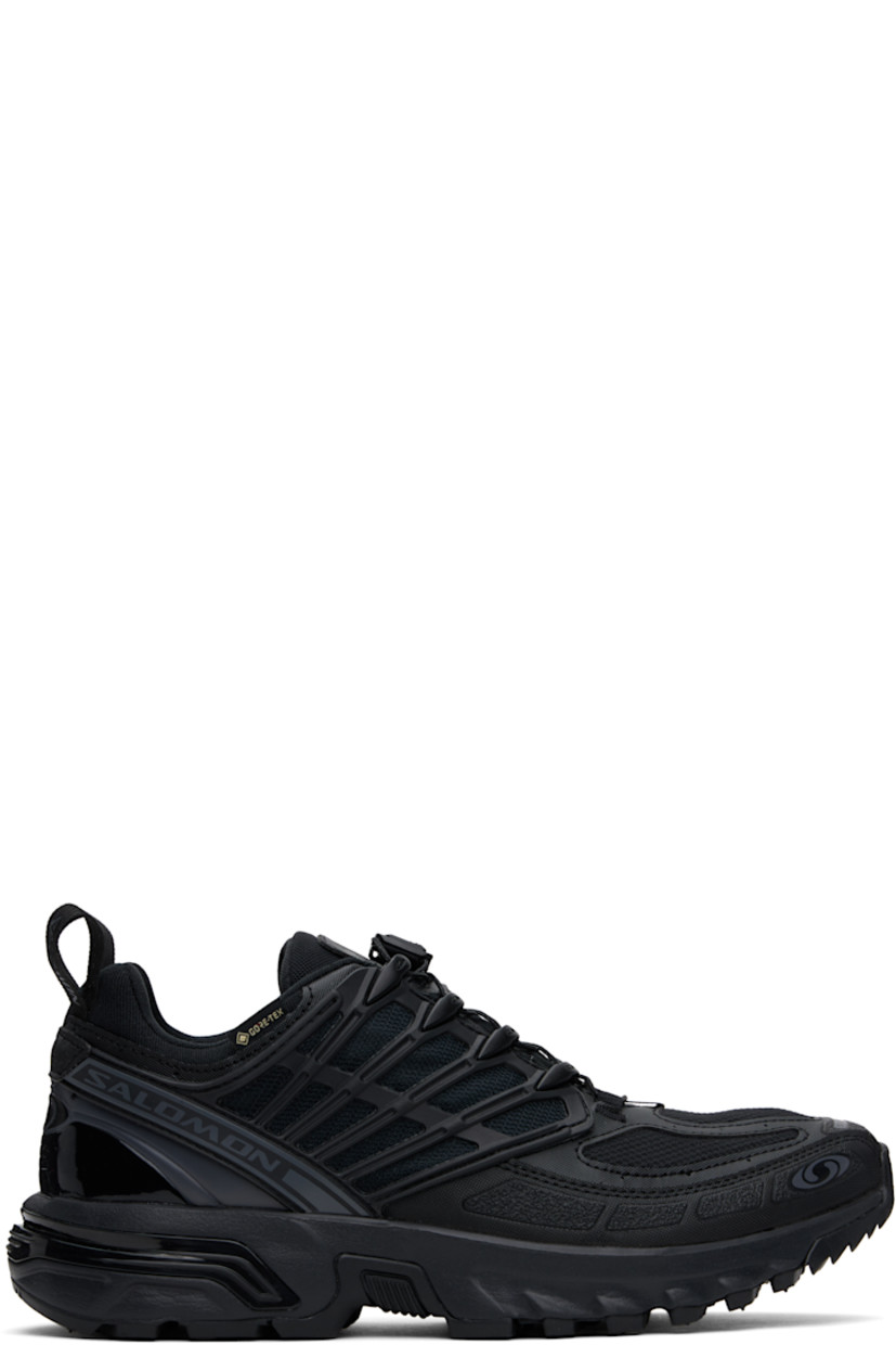 Low-top GORE-TEX™ mesh and textured faux-leather sneakers in black.

· Waterproof and anti-debris
· Rubberized trim throughout
· Logos bonded at toe
· Quicklace™ closure
· Logo patch at vamp
· Velcro tab and logo patch at padded tongue
· Padded collar
· SensiFit™ panel at sides
· Printed logo and logo flag at outer side
· Logo-bonded pull-loops at heel tab
· Logo embossed at heel counter
· Cushioned OrthoLite® insole
· Jersey and mesh lining
· Foam rubber EnergyCell midsole
· Agile Chassis™ Skeleton at midsole
· Treaded Mud Contagrip® rubber sole

Supplier color: Black/Black/Asphalt