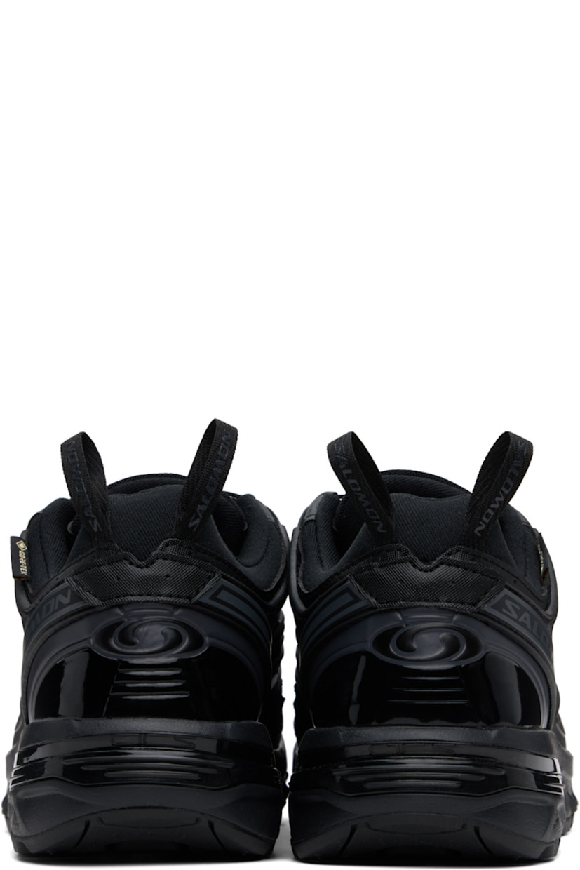 Low-top GORE-TEX™ mesh and textured faux-leather sneakers in black.

· Waterproof and anti-debris
· Rubberized trim throughout
· Logos bonded at toe
· Quicklace™ closure
· Logo patch at vamp
· Velcro tab and logo patch at padded tongue
· Padded collar
· SensiFit™ panel at sides
· Printed logo and logo flag at outer side
· Logo-bonded pull-loops at heel tab
· Logo embossed at heel counter
· Cushioned OrthoLite® insole
· Jersey and mesh lining
· Foam rubber EnergyCell midsole
· Agile Chassis™ Skeleton at midsole
· Treaded Mud Contagrip® rubber sole

Supplier color: Black/Black/Asphalt