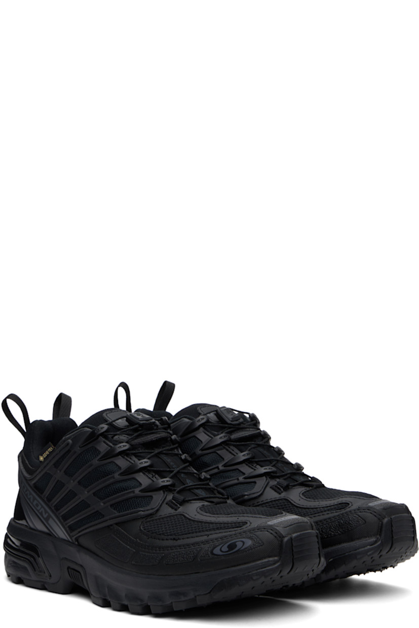 Low-top GORE-TEX™ mesh and textured faux-leather sneakers in black.

· Waterproof and anti-debris
· Rubberized trim throughout
· Logos bonded at toe
· Quicklace™ closure
· Logo patch at vamp
· Velcro tab and logo patch at padded tongue
· Padded collar
· SensiFit™ panel at sides
· Printed logo and logo flag at outer side
· Logo-bonded pull-loops at heel tab
· Logo embossed at heel counter
· Cushioned OrthoLite® insole
· Jersey and mesh lining
· Foam rubber EnergyCell midsole
· Agile Chassis™ Skeleton at midsole
· Treaded Mud Contagrip® rubber sole

Supplier color: Black/Black/Asphalt