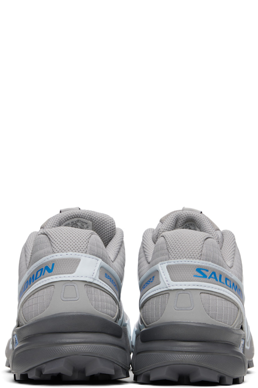Low-top mesh and buffed faux-leather sneakers in gray.

· Reflective trim throughout
· Quicklace™ closure
· Logo patch at vamp and tongue
· Padded tongue and collar
· Logo printed at outer side
· sensiFIT™ panel at sides
· Molded OrthoLite® footbed
· Mesh lining
· Foam rubber midsole
· Treaded Mud Contagrip® rubber sole

Supplier color: Alloy/Ballad blue/Castlerock