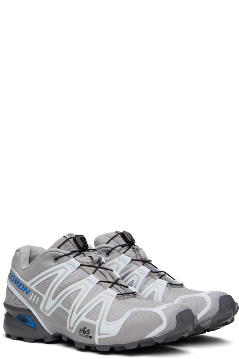 Low-top mesh and buffed faux-leather sneakers in gray.

· Reflective trim throughout
· Quicklace™ closure
· Logo patch at vamp and tongue
· Padded tongue and collar
· Logo printed at outer side
· sensiFIT™ panel at sides
· Molded OrthoLite® footbed
· Mesh lining
· Foam rubber midsole
· Treaded Mud Contagrip® rubber sole

Supplier color: Alloy/Ballad blue/Castlerock