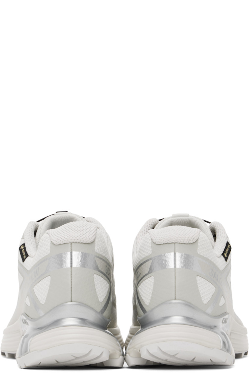 Low-top mesh sneakers in gray.

· Waterproof GORE-TEX™ membrane
· Reflective trim throughout
· Rubber cap toe
· Quicklace™ closure
· Logo patch at vamp
· Logo-woven pull-loop at padded tongue
· Padded collar
· Logo printed at sides
· Bonded SensiFit™ panel at sides
· Logo flag at outer side
· Molded OrthoLite® insole
· Mesh lining
· Agile Chassis™ System at foam rubber EnergyCell midsole
· Treaded Mud Contagrip® rubber sole

Supplier color: Lunar rock/Alloy/Ftw silver