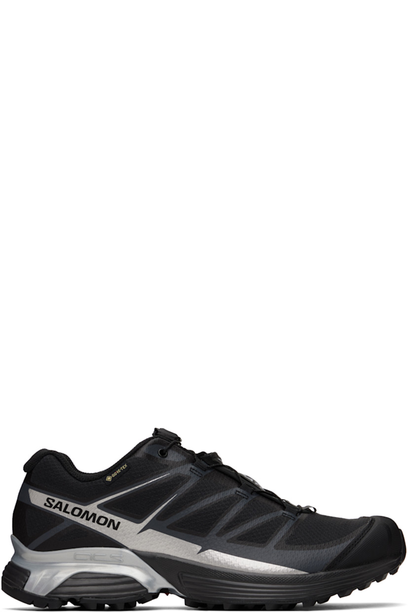 Low-top mesh sneakers in black.

· Waterproof PFC-free GORE-TEX™ membrane
· Reflective trim throughout
· Rubber cap toe
· Quicklace™ closure
· Logo patch at vamp 
· Logo-woven pull-loop at padded tongue
· Padded collar
· Logo printed at sides
· Bonded SensiFit™ panel at sides
· Logo flag at outer side
· Molded OrthoLite® footbed
· Mesh lining
· Agile Chassis™ System at foam rubber EnergyCell midsole
· Treaded Mud Contagrip® rubber sole

Supplier color: Black/Ftw silver