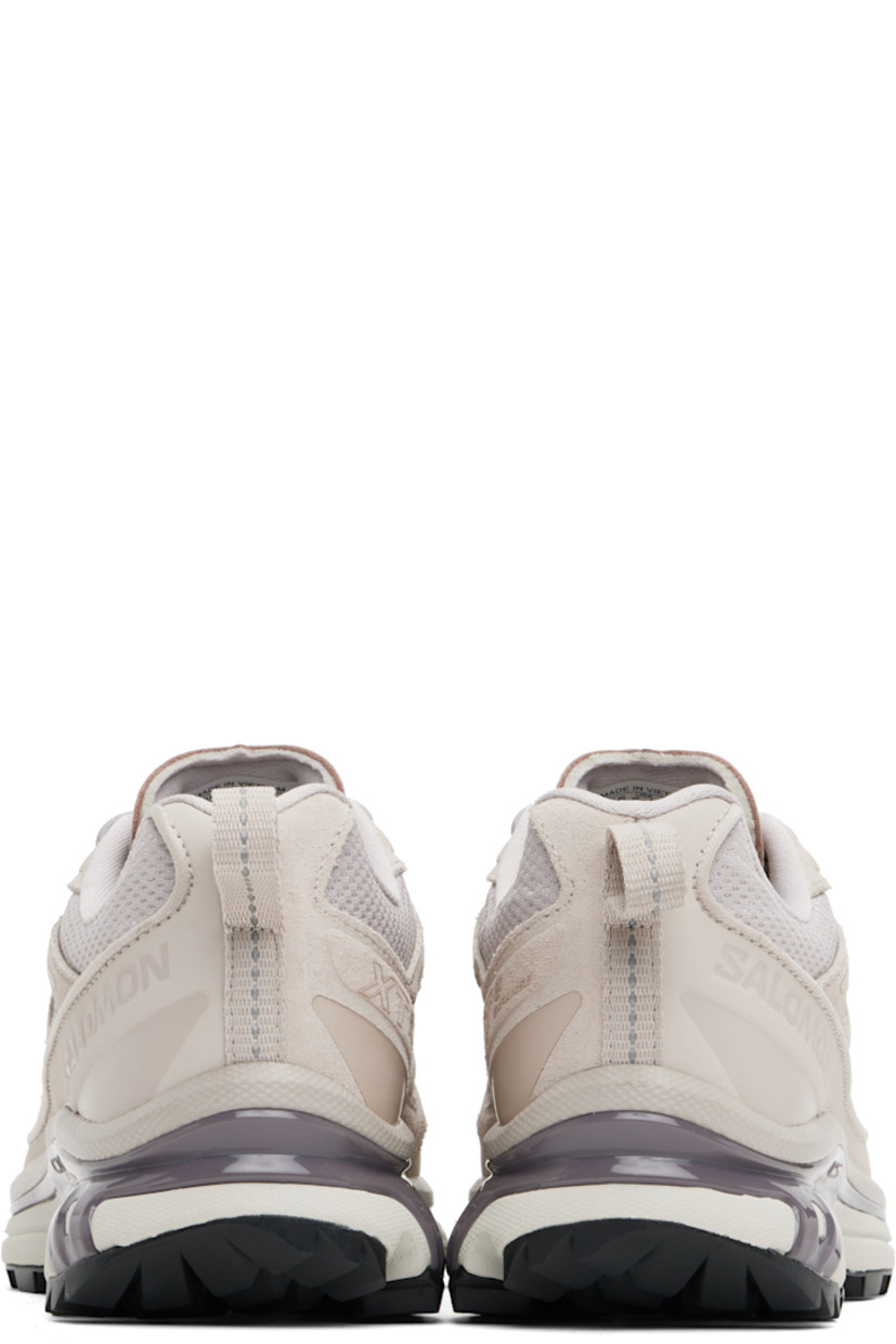 Low-top nubuck, suede, and mesh sneakers in taupe.

· Reflective bonded trim throughout
· Buffed leather cap toe
· Lace-up closure
· Logo embossed at padded tongue
· Padded collar
· SensiFit™ panel at sides
· Text printed at inner side
· Logo embossed at outer side
· Pull-loop at heel tab
· Molded OrthoLite® footbed
· Mesh lining
· Agile Chassis™ System at rubber EnergyCell midsole
· Treaded Mud Contagrip® rubber sole

Supplier color: Ashes of roses/Excalibur