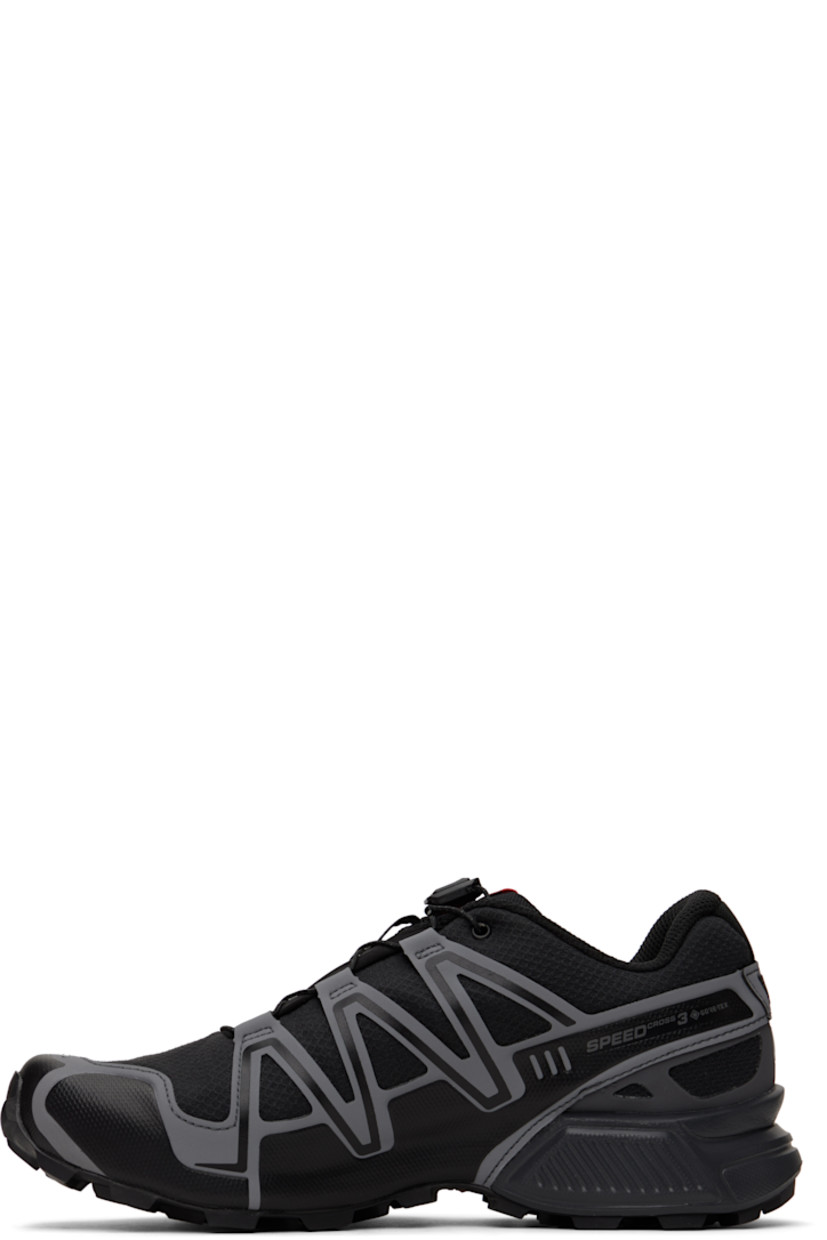 Low-top lightweight mesh sneakers in black.

· Waterproof PFC-free GORE-TEX™ membrane
· Reflective trim throughout
· Quicklace™ closure
· Logo patch at vamp
· Logo-woven pull-loop at padded tongue
· Padded collar
· Bonded sensiFit™ panel at sides
· Reflective logo printed at outer side
· Molded OrthoLite® footbed
· Mesh lining
· Lightweight Muscle foam rubber midsole
· Treaded Mud Contagrip® rubber outsole

Supplier color: Black/Asphalt/Flame scarlet