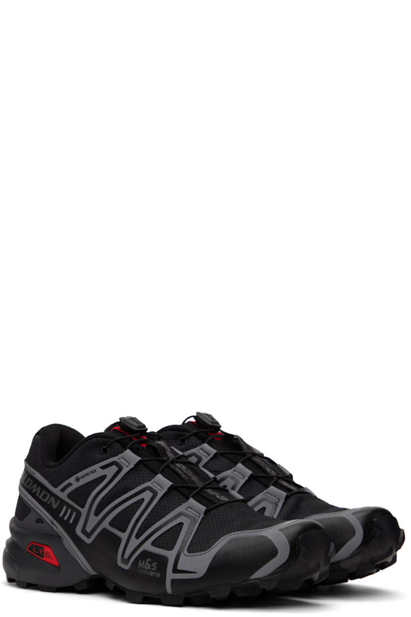 Low-top lightweight mesh sneakers in black.

· Waterproof PFC-free GORE-TEX™ membrane
· Reflective trim throughout
· Quicklace™ closure
· Logo patch at vamp
· Logo-woven pull-loop at padded tongue
· Padded collar
· Bonded sensiFit™ panel at sides
· Reflective logo printed at outer side
· Molded OrthoLite® footbed
· Mesh lining
· Lightweight Muscle foam rubber midsole
· Treaded Mud Contagrip® rubber outsole

Supplier color: Black/Asphalt/Flame scarlet