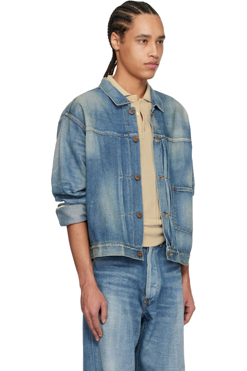 Non-stretch denim jacket. Fading, whiskering, and subtle distressing throughout.

· Spread collar
· Button closure
· Pintucks at front
· Patch pocket
· Buttoned barrel cuffs
· Pleats at back yoke
· Cinch strap at back
· Contrast stitching in tan

Supplier color: Damaged indigo