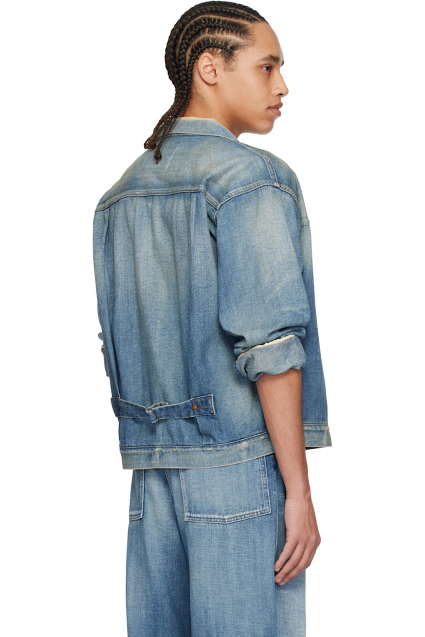 Non-stretch denim jacket. Fading, whiskering, and subtle distressing throughout.

· Spread collar
· Button closure
· Pintucks at front
· Patch pocket
· Buttoned barrel cuffs
· Pleats at back yoke
· Cinch strap at back
· Contrast stitching in tan

Supplier color: Damaged indigo