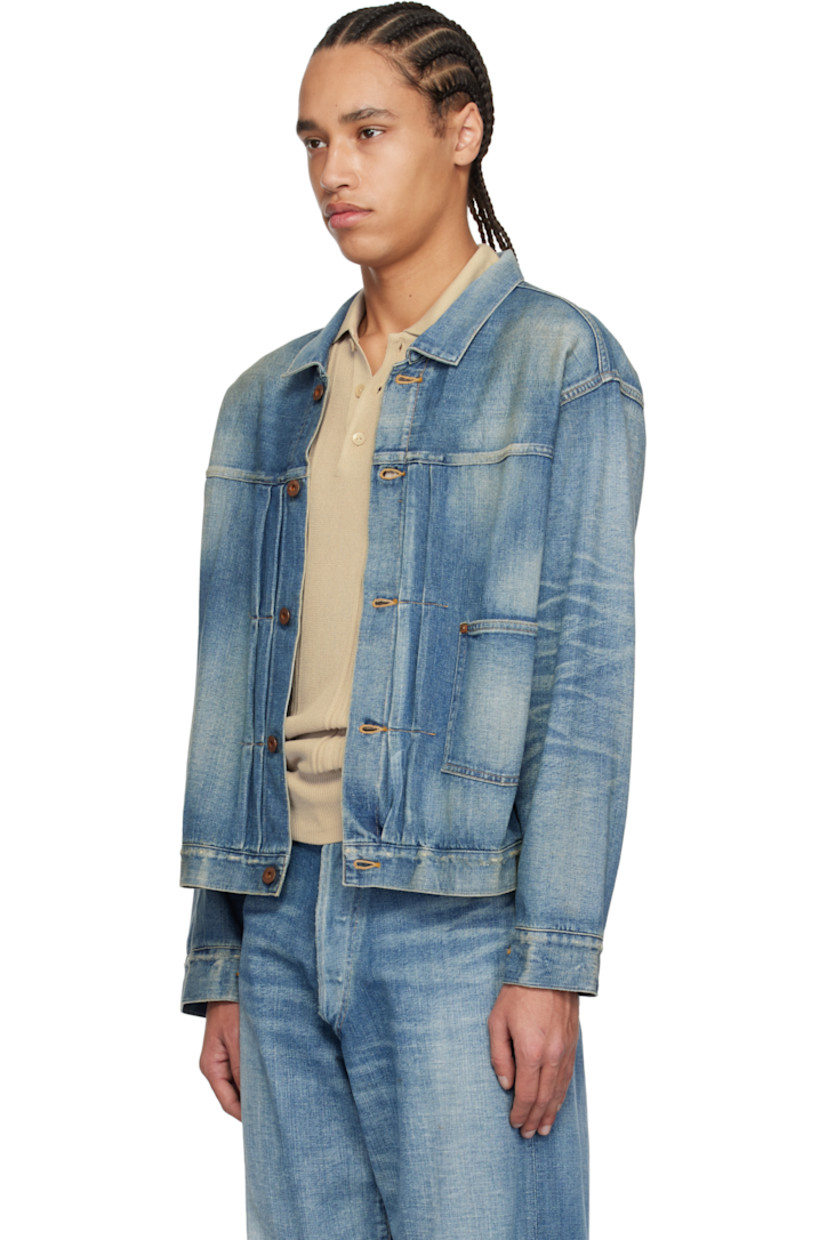 Non-stretch denim jacket. Fading, whiskering, and subtle distressing throughout.

· Spread collar
· Button closure
· Pintucks at front
· Patch pocket
· Buttoned barrel cuffs
· Pleats at back yoke
· Cinch strap at back
· Contrast stitching in tan

Supplier color: Damaged indigo