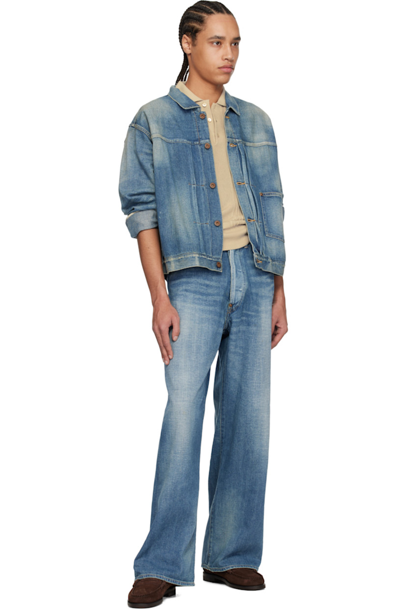 Non-stretch denim jacket. Fading, whiskering, and subtle distressing throughout.

· Spread collar
· Button closure
· Pintucks at front
· Patch pocket
· Buttoned barrel cuffs
· Pleats at back yoke
· Cinch strap at back
· Contrast stitching in tan

Supplier color: Damaged indigo
