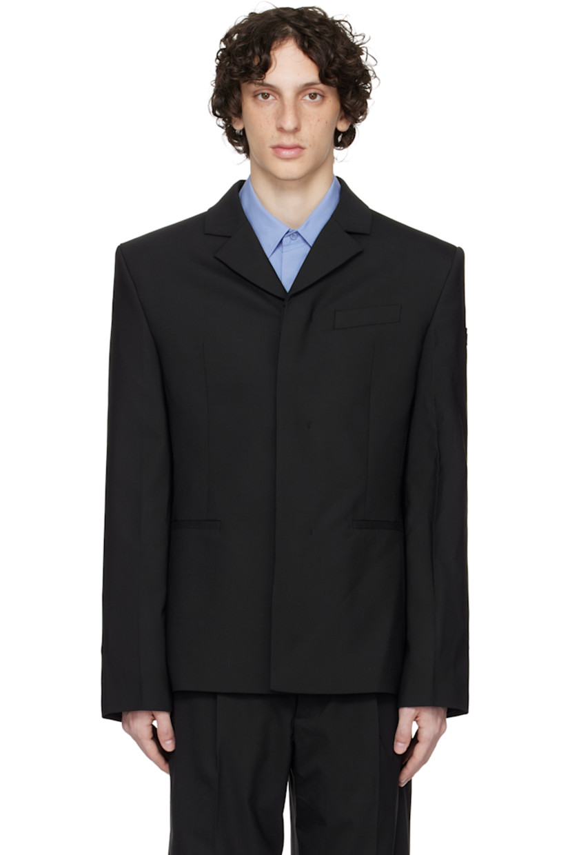 Plain-woven stretch polyester- and wool-blend blazer.

· Notched lapel
· Concealed button closure
· Welt pockets and darts at front 
· Padded shoulders
· Embroidered logo patch at sleeve
· Buttoned surgeon's cuffs
· Central vent at back hem 
· Welt pockets at interior 
· Full satin lining 

Supplier color: Black