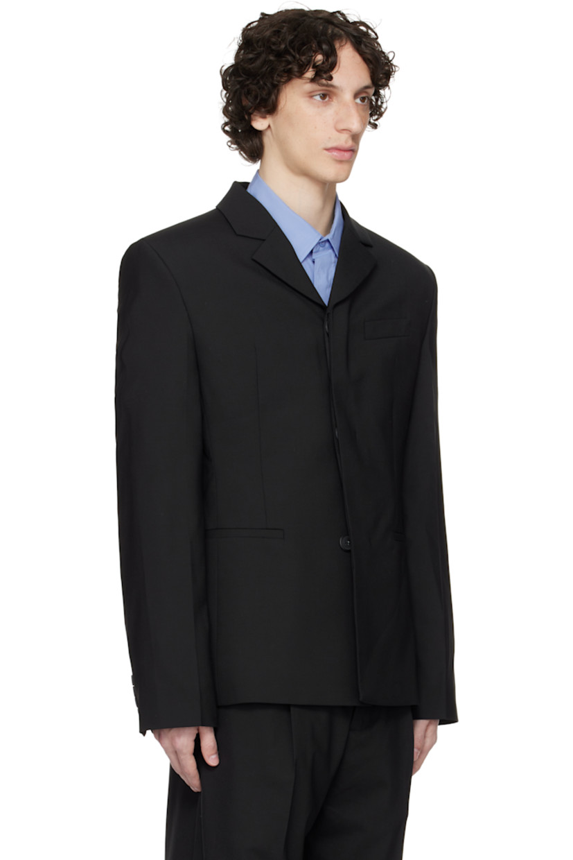 Plain-woven stretch polyester- and wool-blend blazer.

· Notched lapel
· Concealed button closure
· Welt pockets and darts at front 
· Padded shoulders
· Embroidered logo patch at sleeve
· Buttoned surgeon's cuffs
· Central vent at back hem 
· Welt pockets at interior 
· Full satin lining 

Supplier color: Black