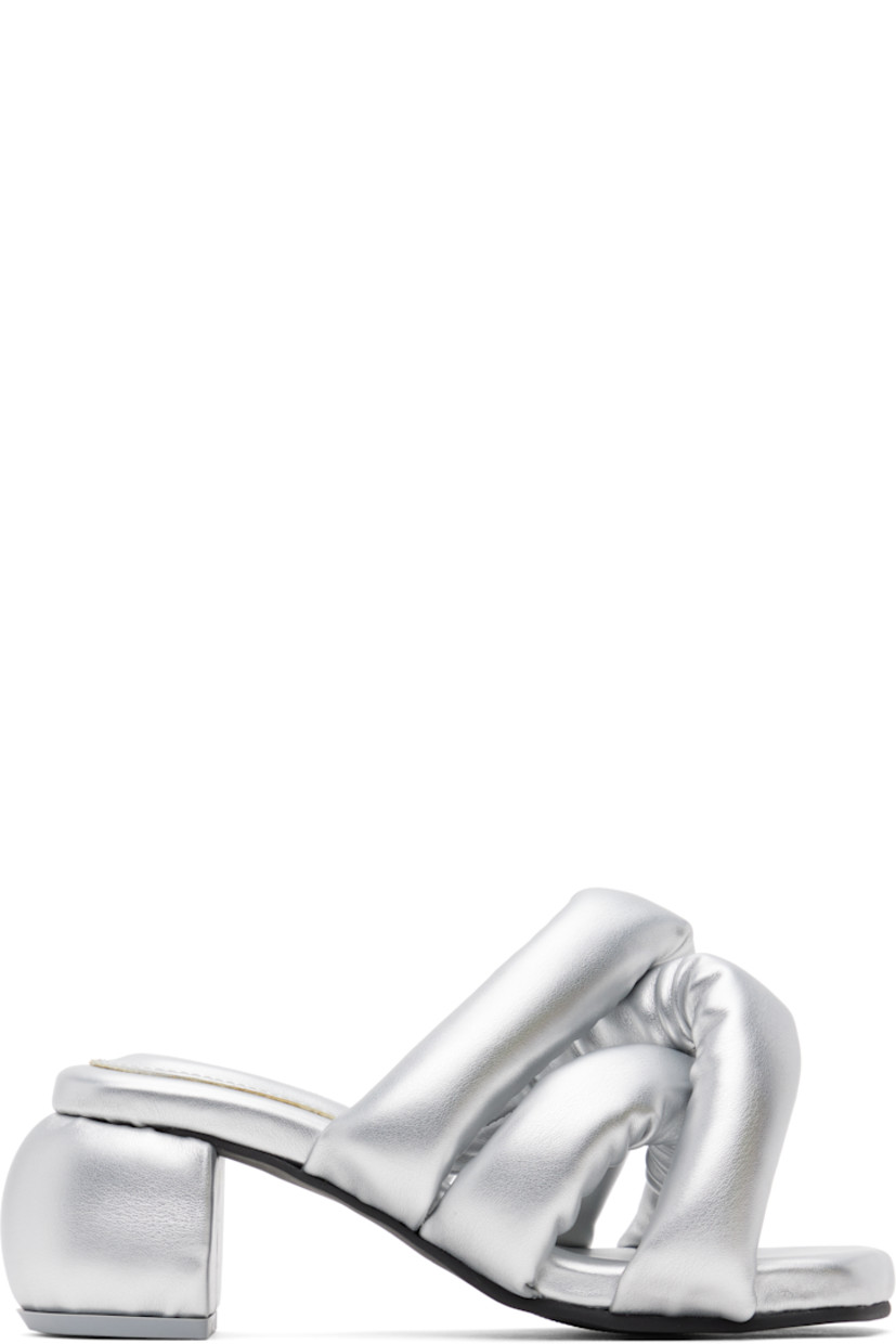 Padded buffed faux-leather slip-on heeled sandals in silver tone.

· Open square toe
· Crisscrossing straps at vamp
· Logo-embossed padded footbed
· Covered block heel
· Treaded rubber sole
· Heel: H2.5"

Supplier color: Silver