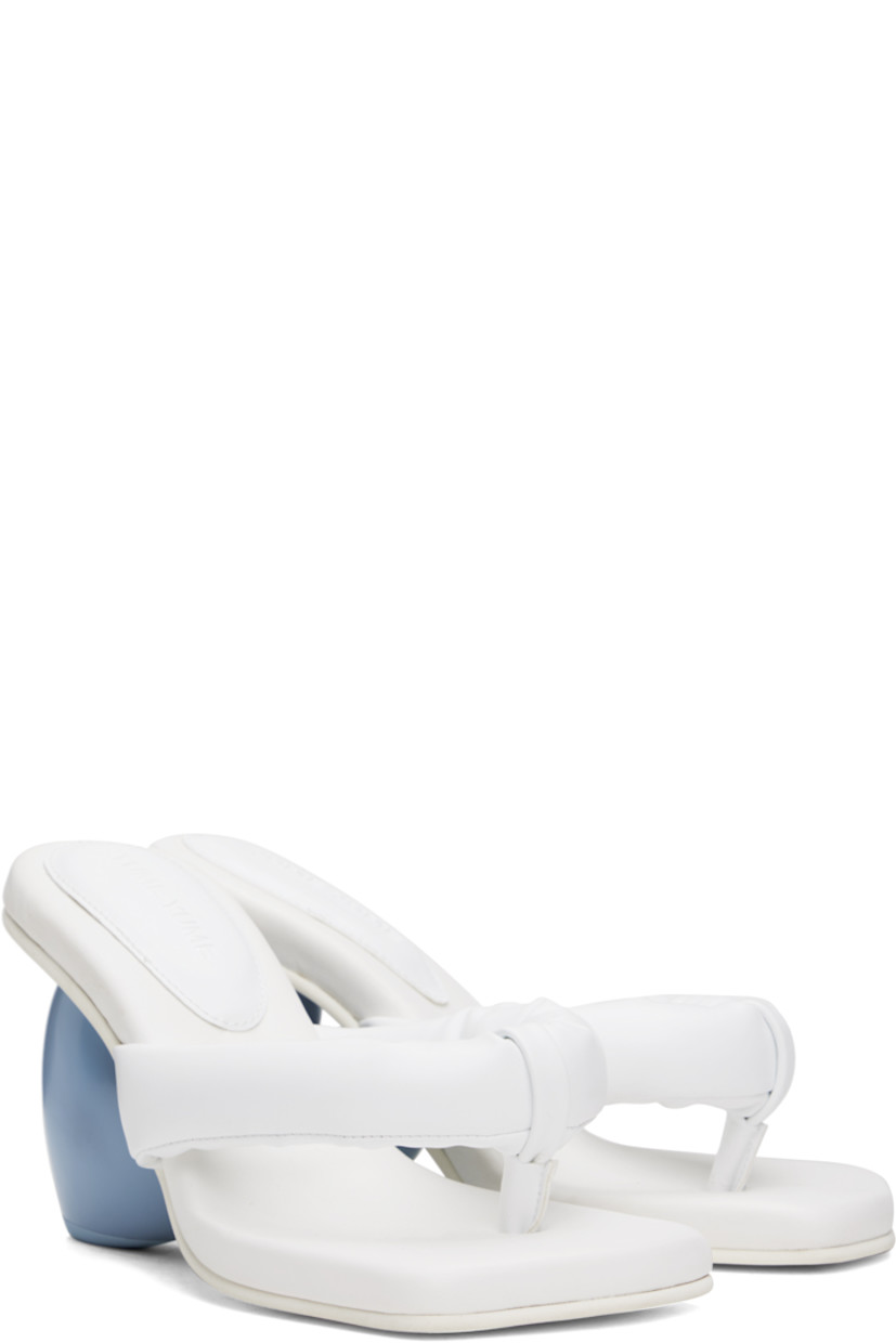 Padded grained faux-leather heeled sandals in white.

· Open square toe
· Thong-style strap at vamp
· Logo stamp at padded footbed
· Sculptural wedge heel with rubber injection
· Treaded rubber sole
· Heel: H3.5"

Supplier color: Snow white/Blue