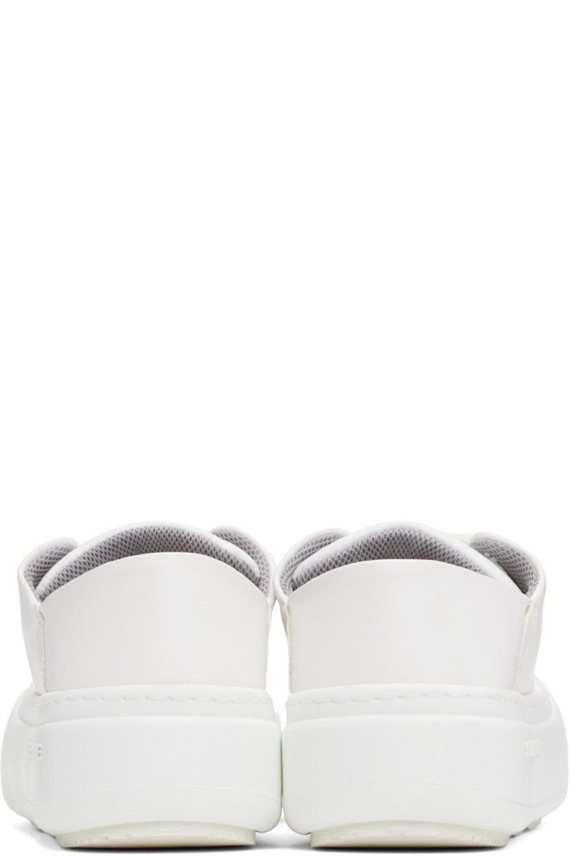 Low-top buffed faux-leather sneakers in white.

· Lace-up closure
· Padded tongue and collar
· Logo stamp at padded footbed
· Mesh and faux-nubuck lining
· Topstitching at welt
· Logo embossed at rubber platform midsole
· Treaded rubber sole
· Platform: H2"

Supplier color: White