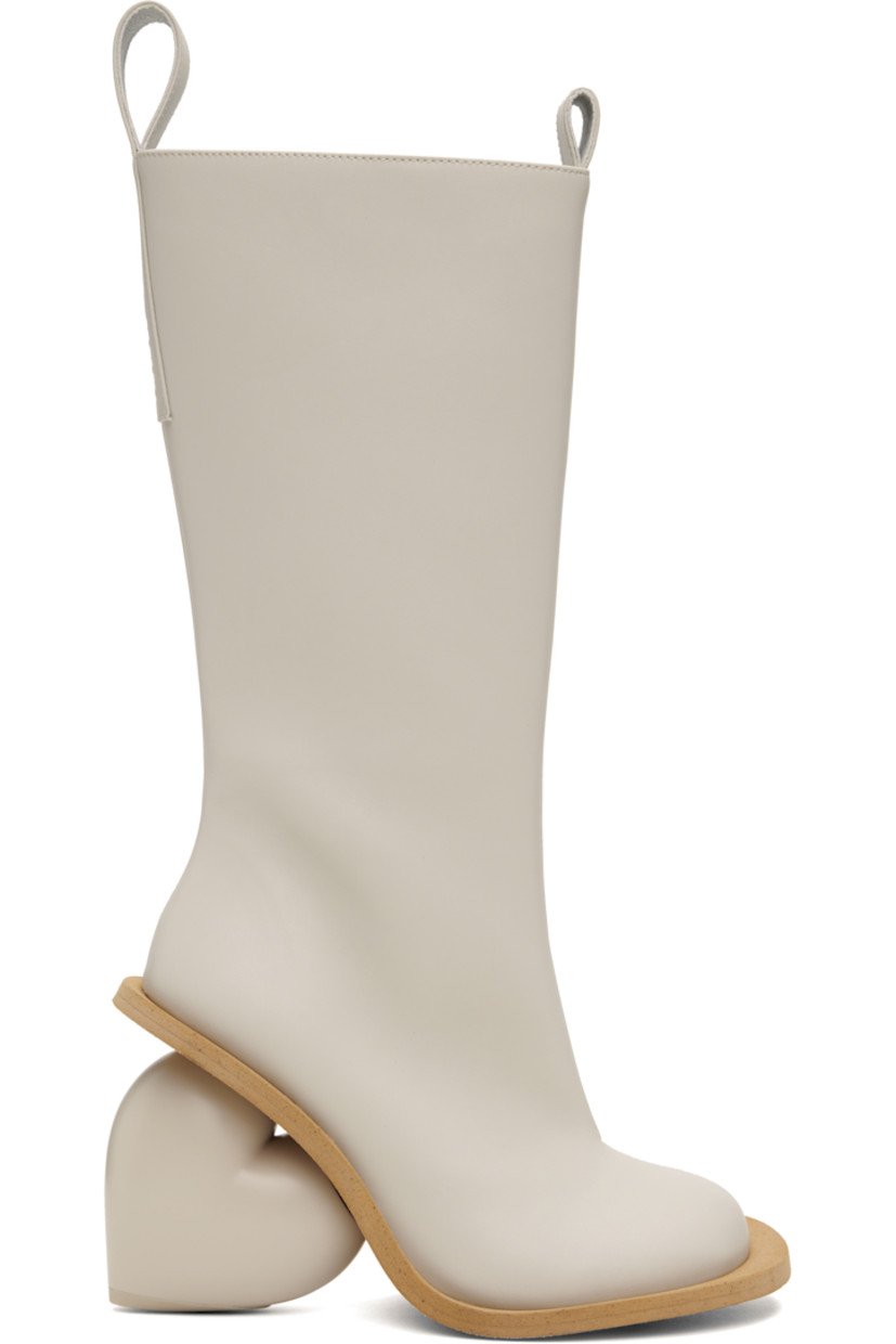 Calf-high buffed faux-leather boots in white.

· Logo-embossed pull-loops at collar
· Zip closure at inner side
· Sculptural wedge heel with rubber injection
· Neolite rubber sole
· Heel: H3.75"

Supplier color: Rainday