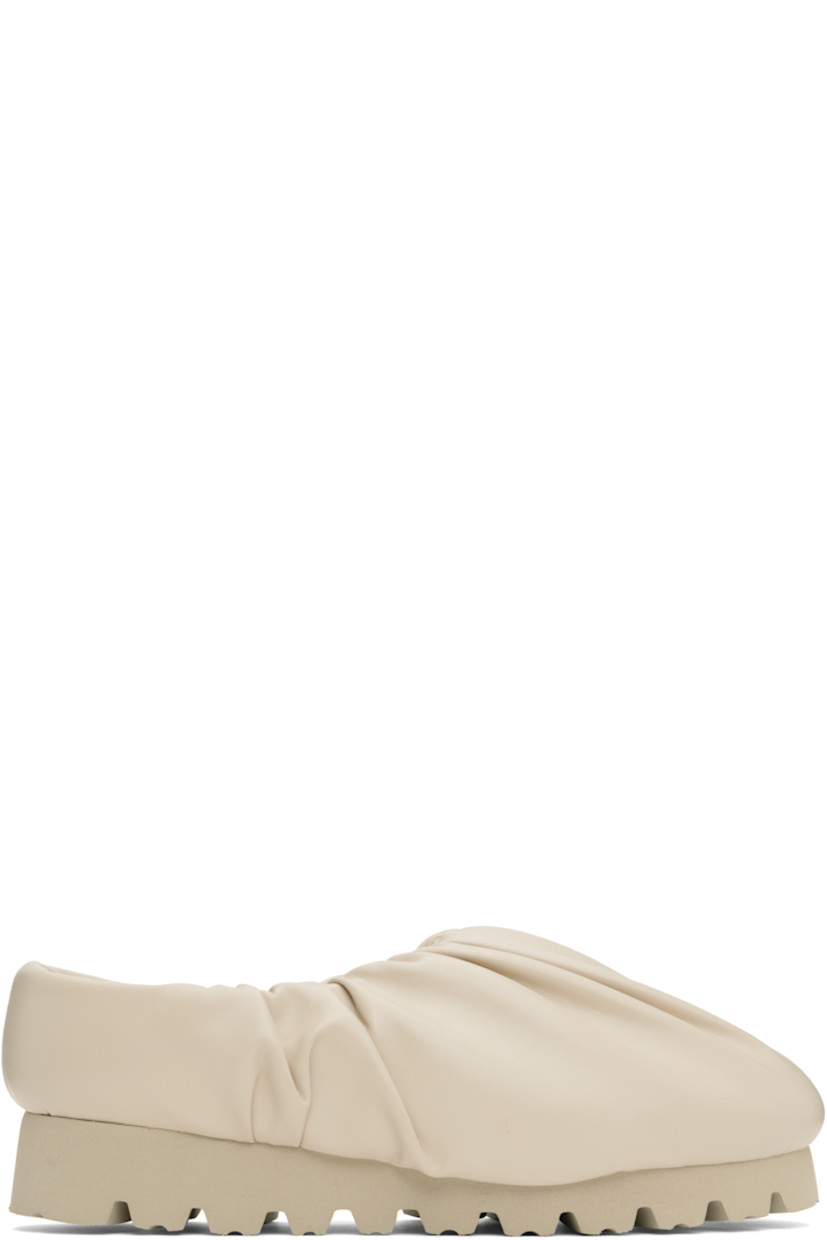 Lightweight buffed faux-leather slip-on loafers in beige. 

· Gathering at collar
· Logo printed at molded footbed
· Grained faux-leather lining
· Treaded foam rubber sole

Supplier color: Beige