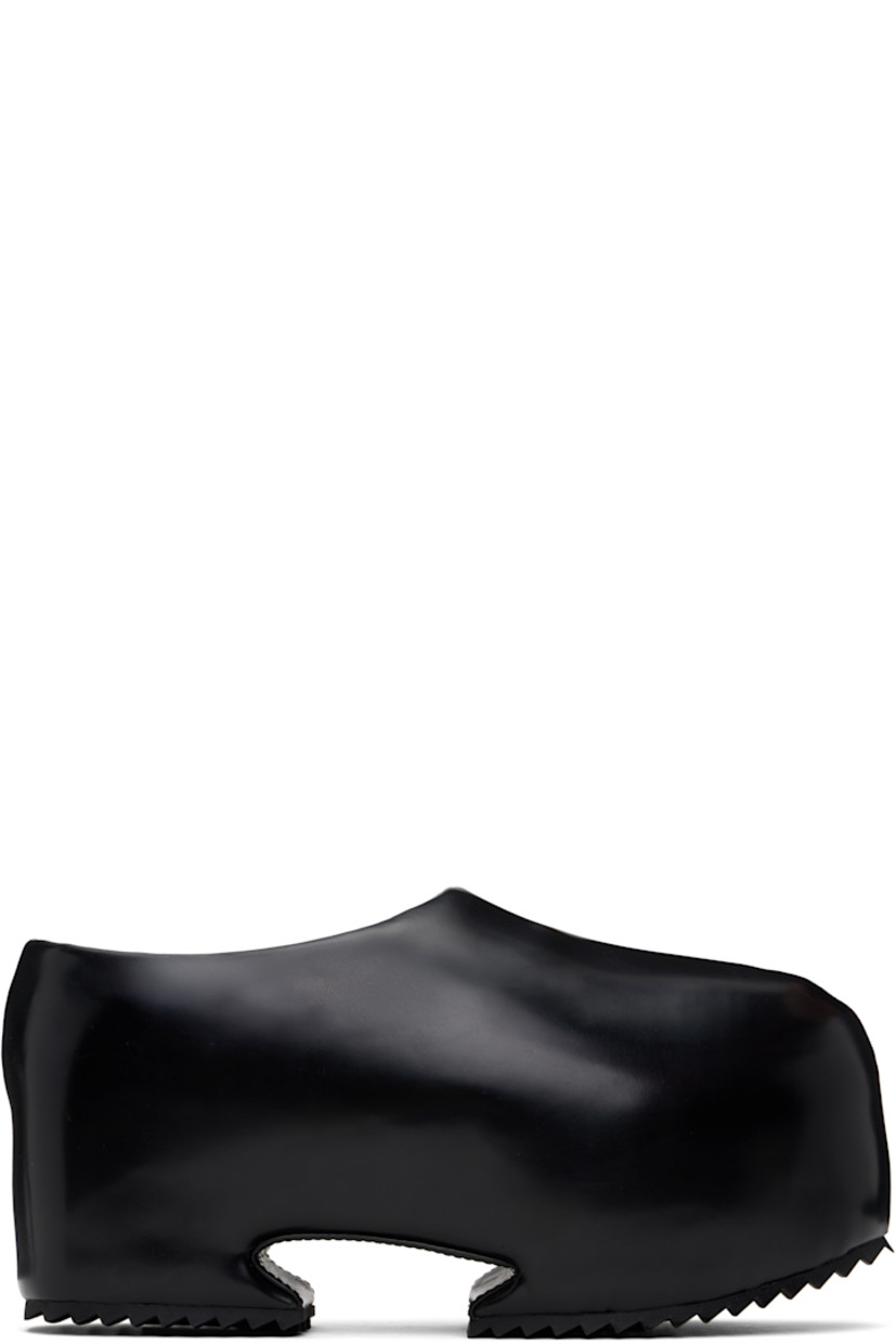 Buffed recycled leather-blend slip-on loafers in black.

· Pointed toe
· Logo embossed at padded footbed
· Cutout at covered platform midsole
· Treaded rubber sole
· Platform: H3"

Supplier color: Shiny black