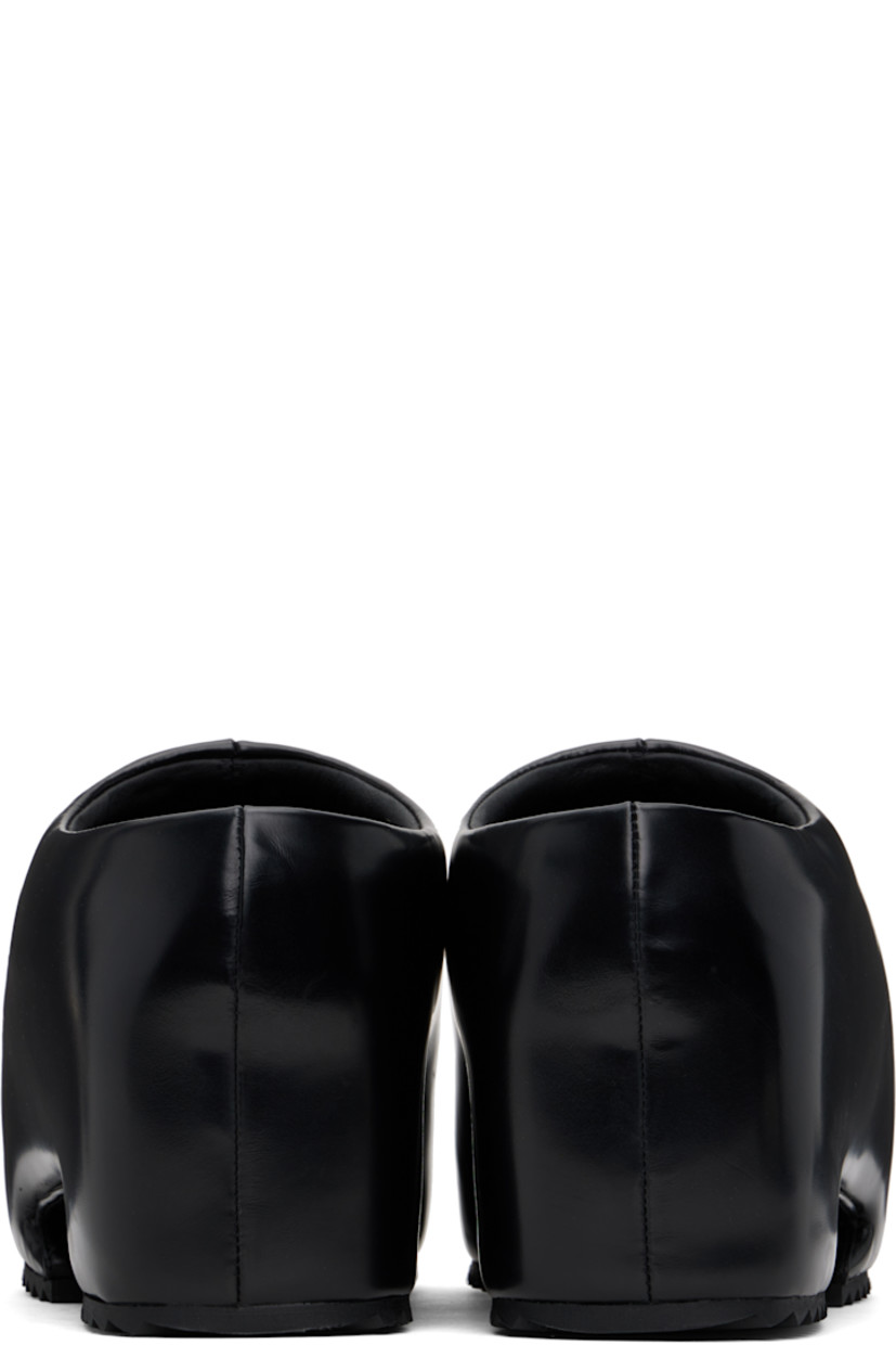 Buffed recycled leather-blend slip-on loafers in black.

· Pointed toe
· Logo embossed at padded footbed
· Cutout at covered platform midsole
· Treaded rubber sole
· Platform: H3"

Supplier color: Shiny black
