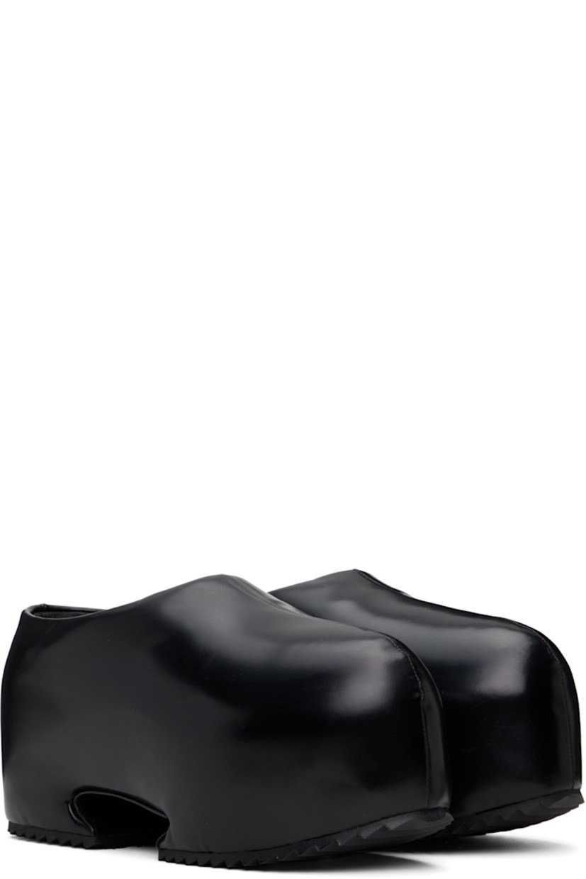 Buffed recycled leather-blend slip-on loafers in black.

· Pointed toe
· Logo embossed at padded footbed
· Cutout at covered platform midsole
· Treaded rubber sole
· Platform: H3"

Supplier color: Shiny black