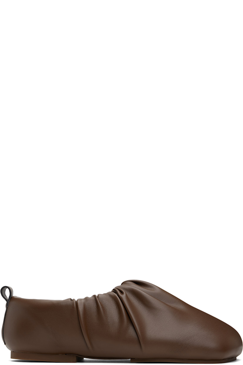Padded buffed faux-leather slip-on loafers in brown. 

· Square toe
· Gathering at collar
· Pull-loop at heel collar
· Logo embossed at padded footbed
· Grained faux-leather lining
· Rubber sole

Supplier color: Marron
