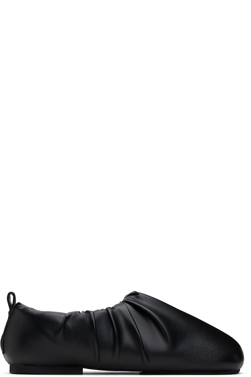 Buffed faux-leather slip-on loafers in black. 

· Square toe
· Gathering at collar
· Pull-loop at heel collar
· Logo embossed at padded footbed
· Grained faux-leather lining
· Rubber sole

Supplier color: Black
