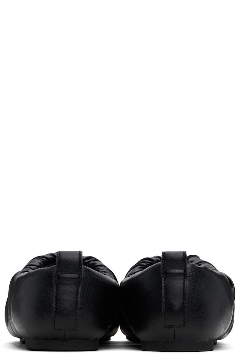 Buffed faux-leather slip-on loafers in black. 

· Square toe
· Gathering at collar
· Pull-loop at heel collar
· Logo embossed at padded footbed
· Grained faux-leather lining
· Rubber sole

Supplier color: Black
