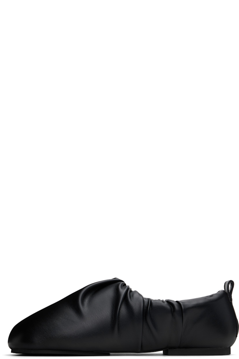 Buffed faux-leather slip-on loafers in black. 

· Square toe
· Gathering at collar
· Pull-loop at heel collar
· Logo embossed at padded footbed
· Grained faux-leather lining
· Rubber sole

Supplier color: Black