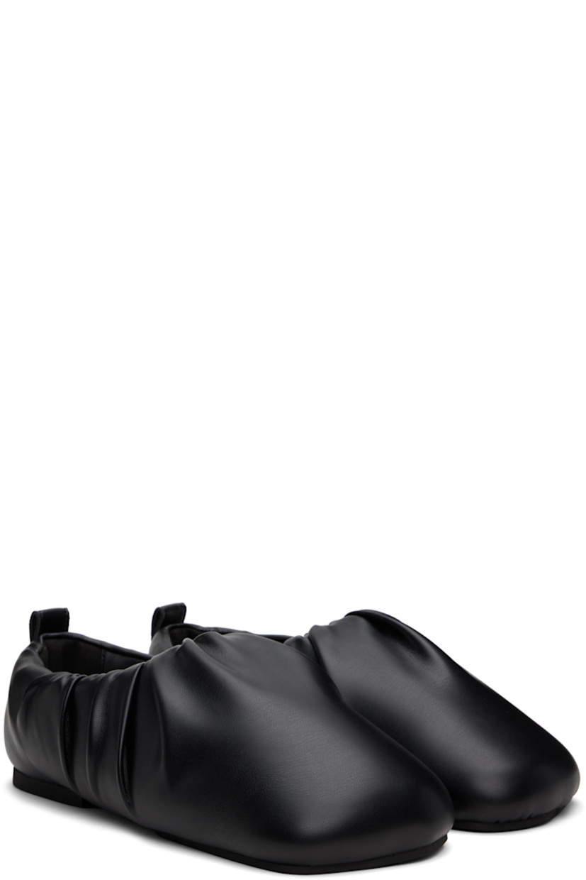 Buffed faux-leather slip-on loafers in black. 

· Square toe
· Gathering at collar
· Pull-loop at heel collar
· Logo embossed at padded footbed
· Grained faux-leather lining
· Rubber sole

Supplier color: Black