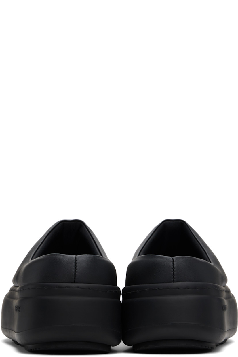 Padded buffed faux-leather slip-on loafers in black. 

· Rubber cap toe
· Logo stamp at molded footbed
· Grained faux-leather lining
· Logo-embossed rubber platform midsole
· Treaded rubber sole
· Platform: H2"

Supplier color: Black