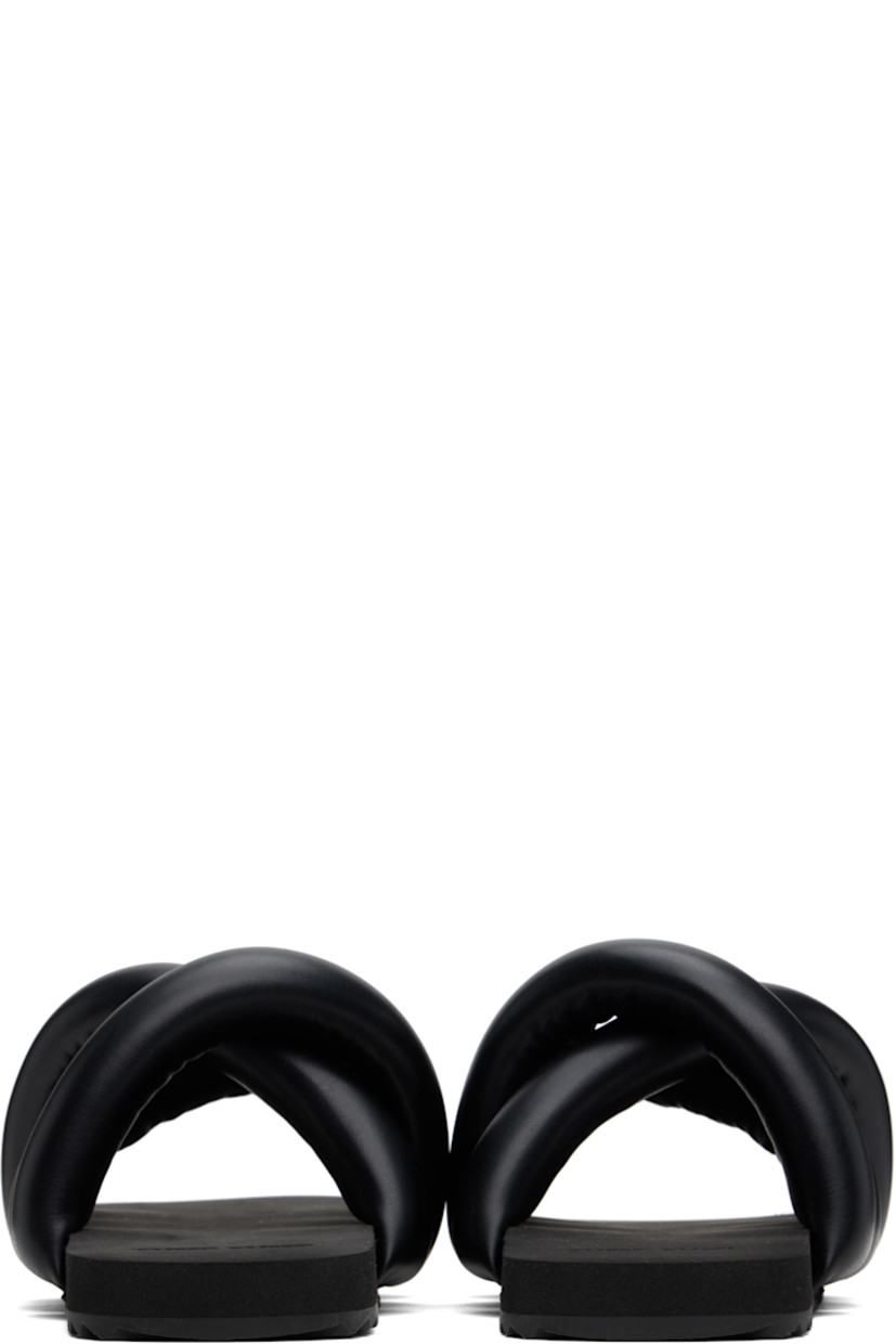 Padded buffed faux-leather slip-on sandals in black.

· Open square toe
· Crisscrossing straps at vamp
· Logo embossed at foam rubber footbed
· Treaded rubber sole

Supplier color: Black