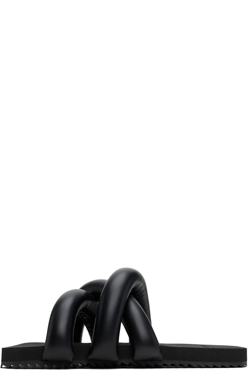 Padded buffed faux-leather slip-on sandals in black.

· Open square toe
· Crisscrossing straps at vamp
· Logo embossed at foam rubber footbed
· Treaded rubber sole

Supplier color: Black