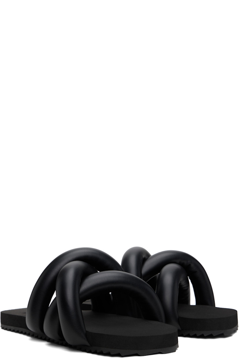 Padded buffed faux-leather slip-on sandals in black.

· Open square toe
· Crisscrossing straps at vamp
· Logo embossed at foam rubber footbed
· Treaded rubber sole

Supplier color: Black