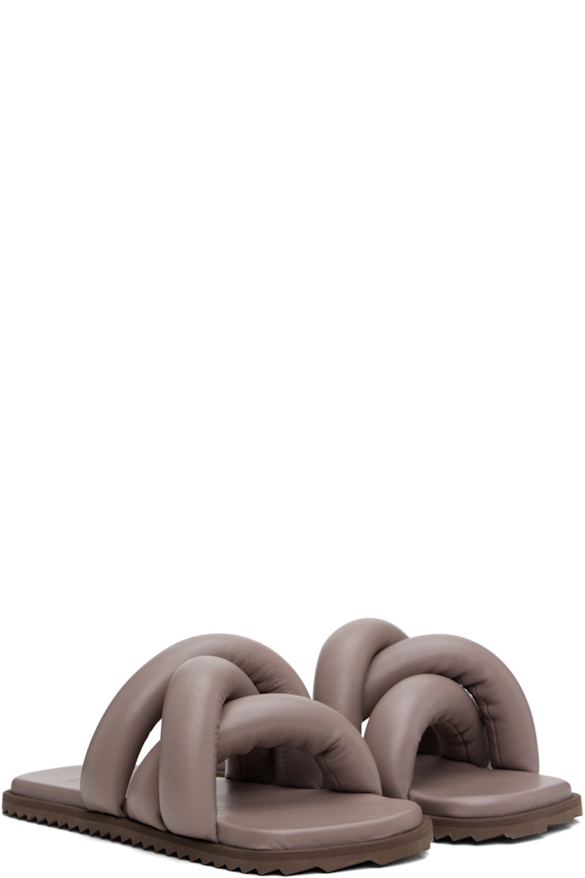 Padded buffed leather slip-on sandals in taupe.

· Open square toe
· Crisscrossing straps at vamp
· Logo embossed at padded buffed faux-leather footbed
· Treaded rubber sole

Supplier color: Castor