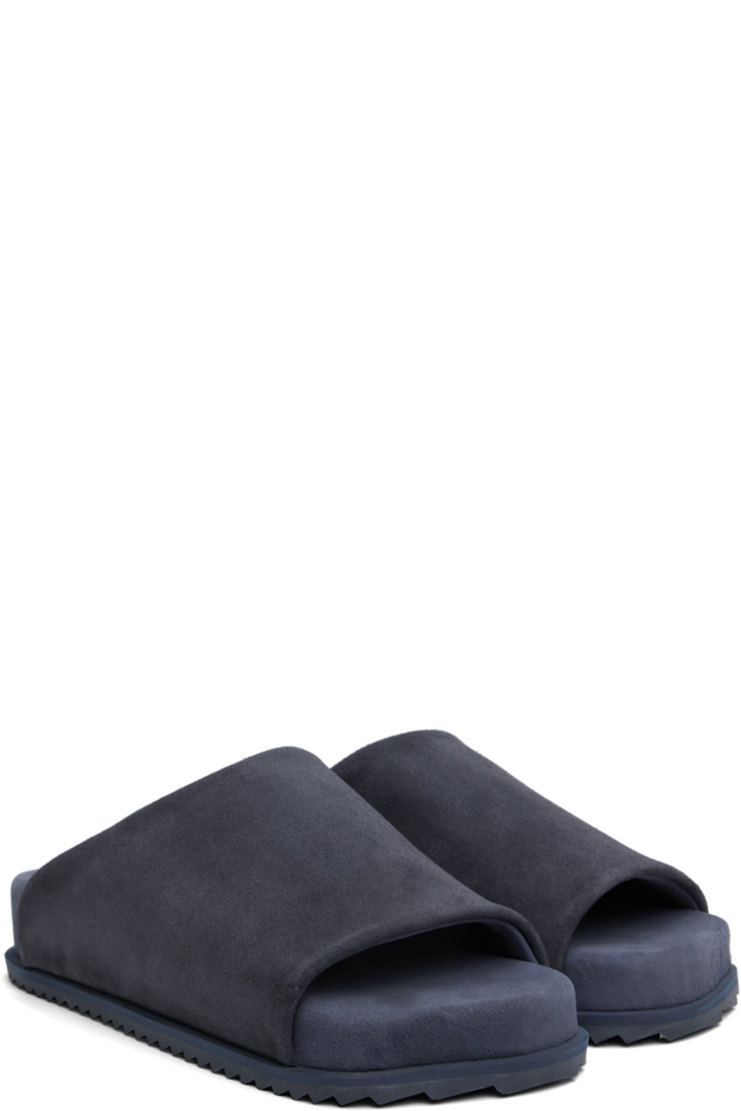 Faux-suede slip-on sandals in navy.

· Open square toe
· Logo embossed at padded faux-suede footbed
· Faux-suede lining
· Treaded rubber sole

Supplier color: Blue navy suede