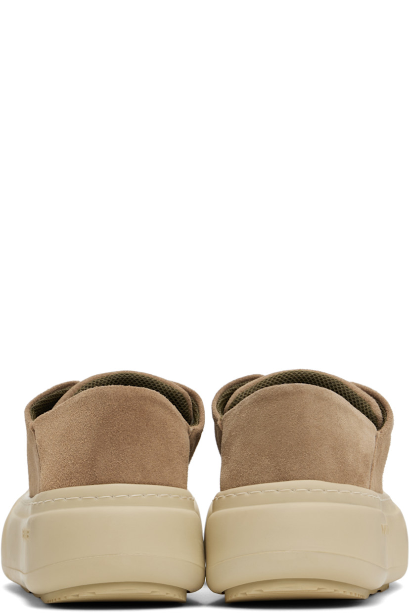 Low-top faux-suede sneakers in brown.

· Lace-up closure
· Padded tongue and collar
· Logo stamp at padded footbed
· Mesh and faux-nubuck lining
· Topstitching at welt
· Logo embossed at rubber platform midsole
· Treaded rubber sole
· Platform: H2"

Supplier color: Cappuccino suede
