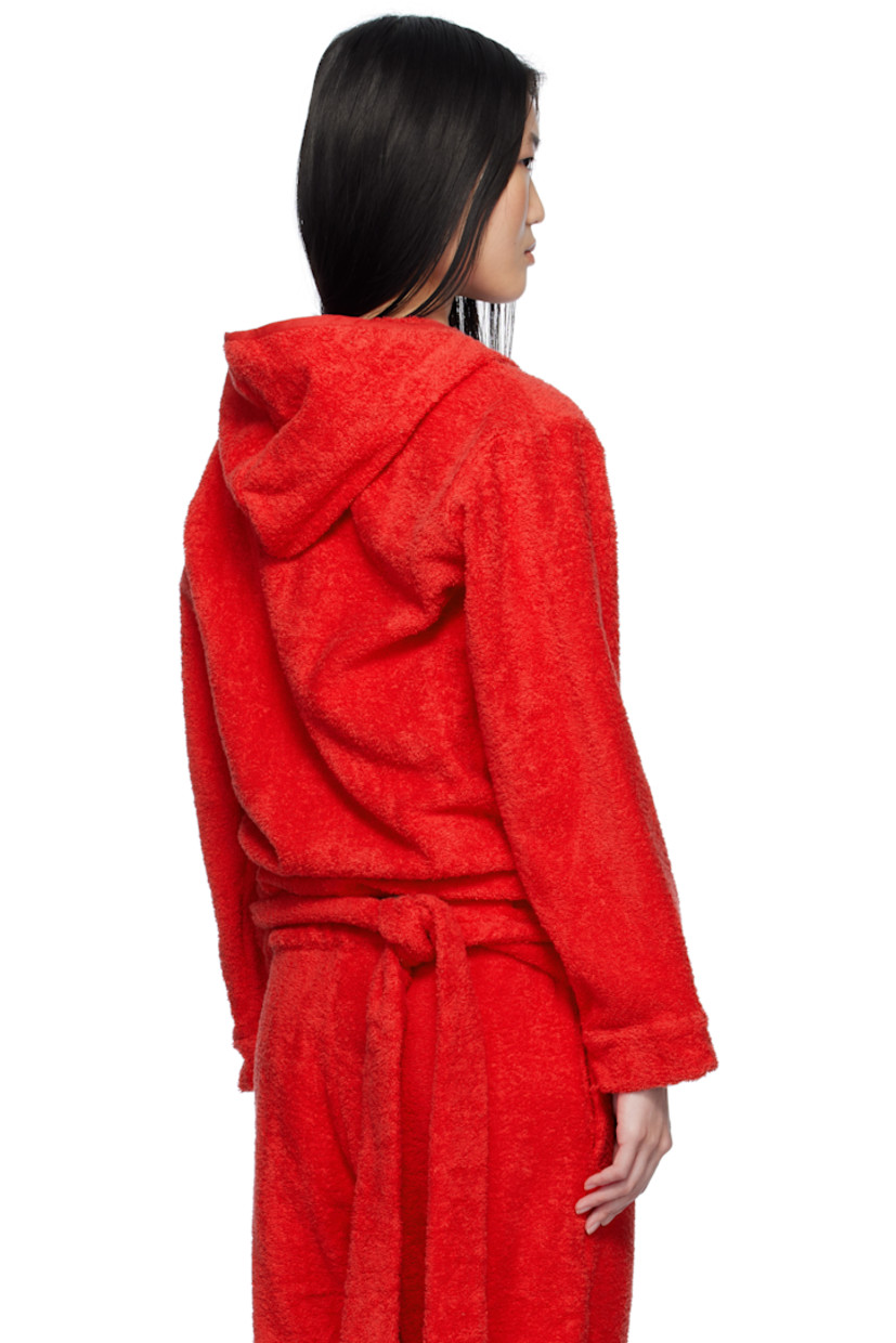 Cotton terrycloth hoodie.

· Wrap construction
· Piping at hood, V-neck, and placket
· Seam pockets
· Self-tie strap at hem
· Logo hardware at front hem
· Dropped shoulders

Supplier color: Terrycloth red